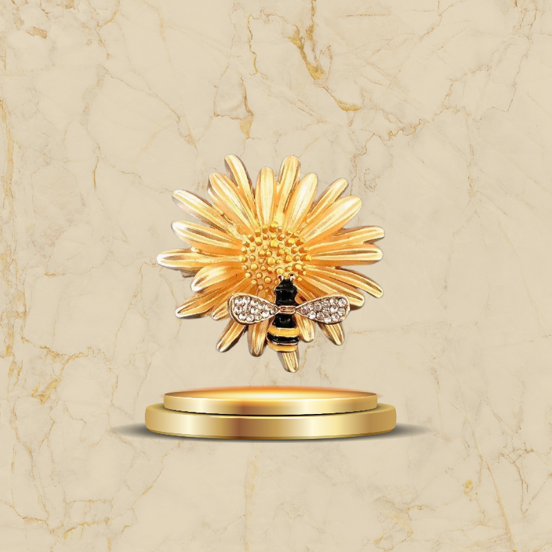 Broche fleur dorée avec abeille décorée de strass