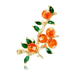 Broche de forme branchée avec une petite orange