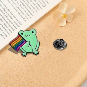 Pin's multicolore avec motif de grenouille et drapeau