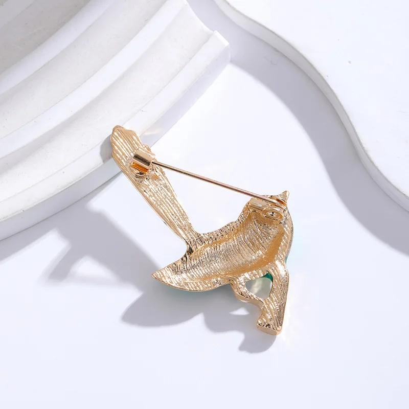 Broche Oiseau Bleu mise en scène avec des vêtements